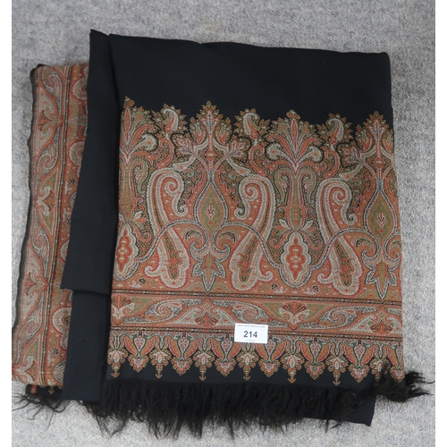 214 - A large black ground paisley shawl with 305cm x 158cm