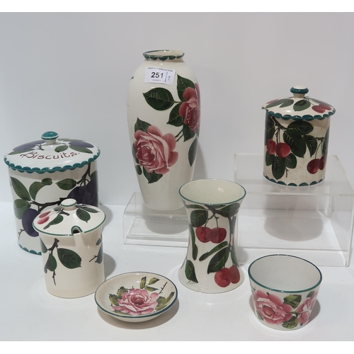 251 - A collection of Wemyss pottery including a plum pattern biscuit barrel, a cabbage rose painted ... 