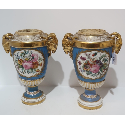 255 - A pair of continental porcelain urns with rams head handles, panted with bouquets of flowers