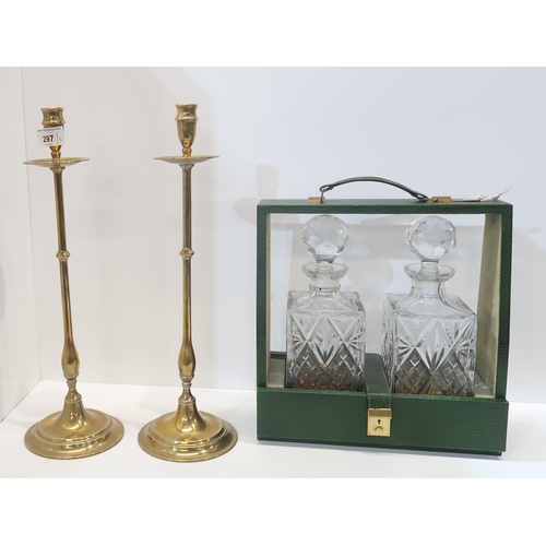 297 - A pair of brass candlesticks, a two bottle leather tantalus and a Jungens mantle clock