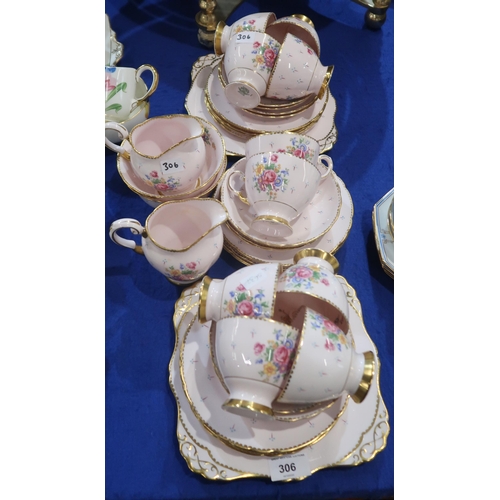 306 - A Tuscan pink ground teaset with floral bouquets comprising ten cups, twelev saucers and plates, two... 