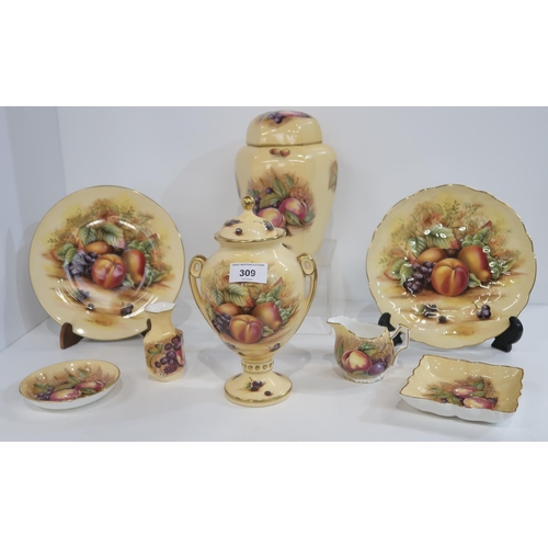 309 - A collection of Aynsley Orchard Gold pattern items including two plates, an urn and cover, jar and c... 