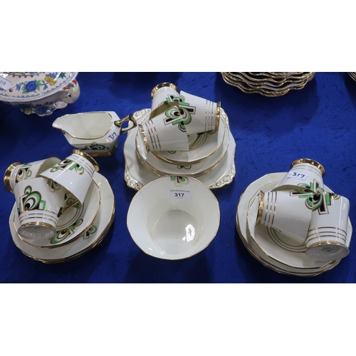 317 - An Art Deco Plant Tuscan teaset, the cream ground with black, green and gilt decoration comprising n... 