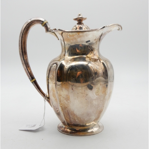 321 - A George V silver hot water pot, of lobed form, on an oval base, the handles with ivory insulators, ... 