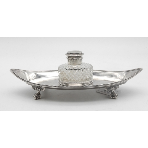 328 - A Victorian silver and glass inkwell, the base of oval form with beaded rims, supported on four brac... 