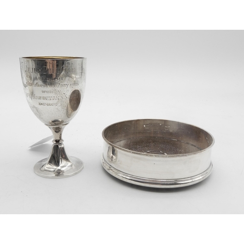 331 - A George V silver goblet, the body with a presentational inscription, on a faceted circular base, by... 