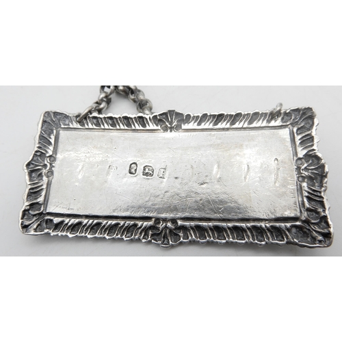 334 - A Georgian silver claret label, with gadrooned shellwork borders, London c.1800's, a silver port lab... 