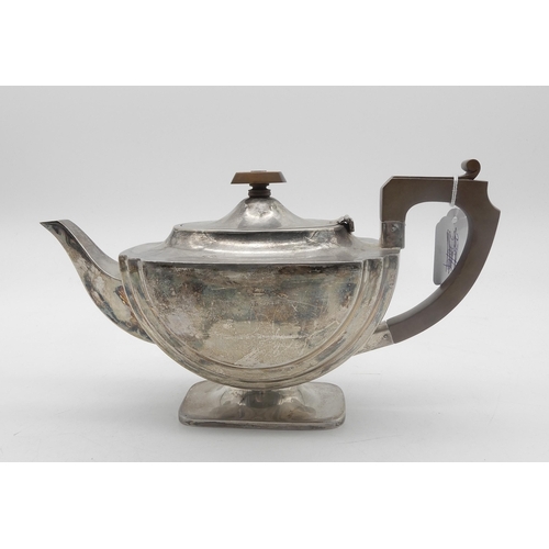 341 - An Art Deco silver tea pot, of stylised form, with a fruitwood handle and finial, by Ernest W H... 