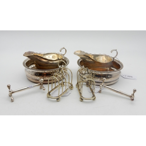 344 - A pair of silver George III style sauceboats, on three pad feet, with flying scroll handles, by Mart... 