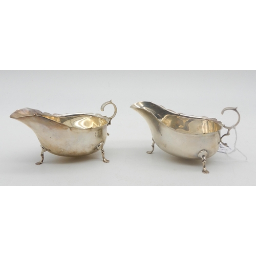 344 - A pair of silver George III style sauceboats, on three pad feet, with flying scroll handles, by Mart... 