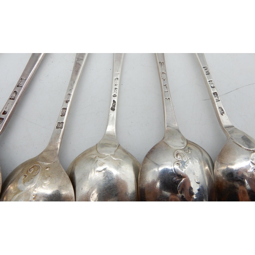 355 - A matched set of twelve George III silver scroll-back Hanoverian pattern dessert spoons, the reverse... 