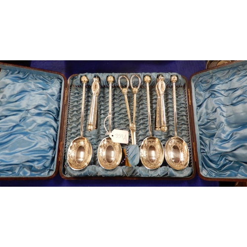 359A - A cased EPNS nut cracker, grape scissor and serving spoon set, with embossed scrolling foliate decor... 