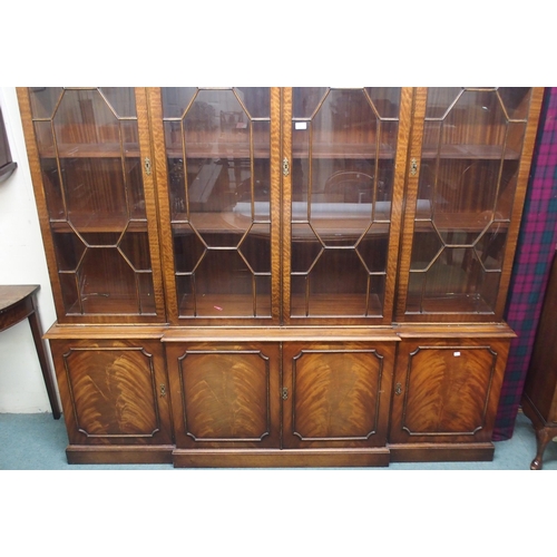 46 - A 20th century mahogany breakfront glazed bookcase with dentil cornice over four astragal glazed doo... 