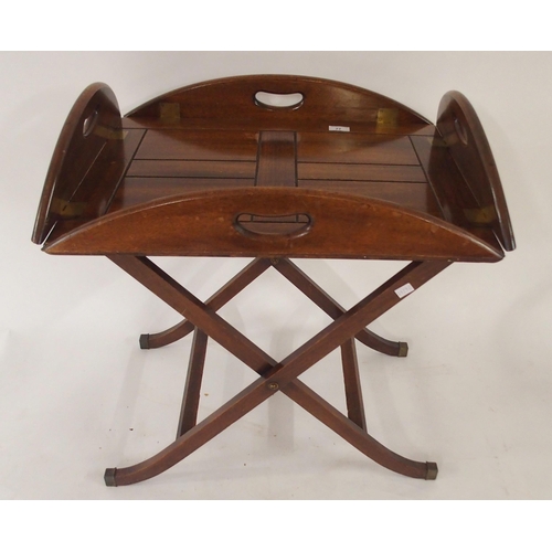 77 - A 20th century mahogany butler tray and stand with drop sides