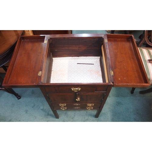 79 - A 19th century mahogany commode with twin hinged lid over pair of cabinet doors over single drawer o... 