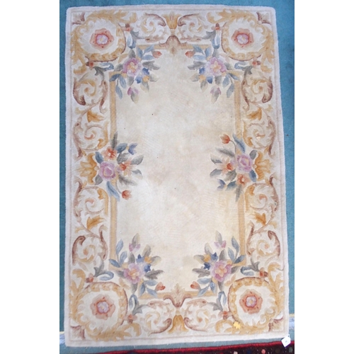 80 - A yellow ground floral bordered wool rug