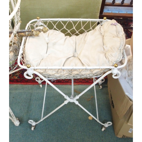 90 - A 19th century wrought iron crib, another smaller crib, baby bath and assorted linens