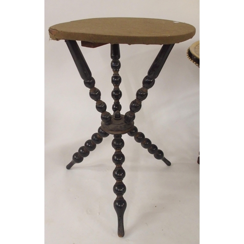 97 - A 20th century Moorish style brass topped folding table, An ebonised circular topped table with turn... 