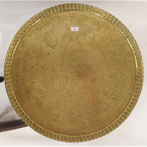 97 - A 20th century Moorish style brass topped folding table, An ebonised circular topped table with turn... 