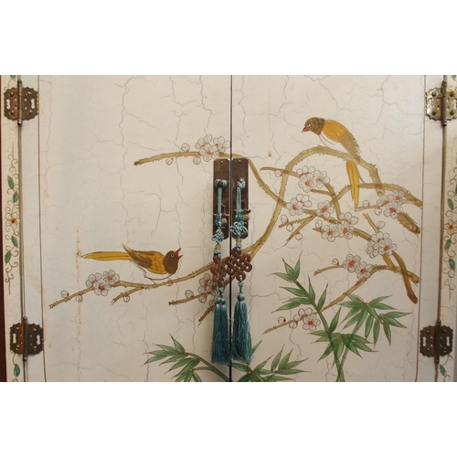 99 - A 20th century Oriental style two door drinks cabinet