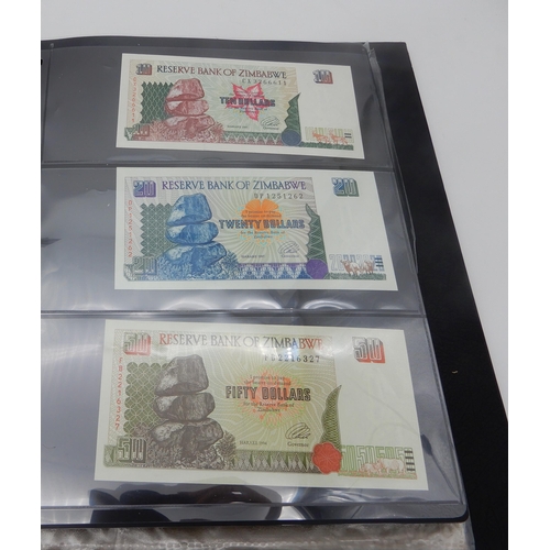 377 - A lot comprising Zimbabwe bank notes featuring a Fifty Trillion Dollars example