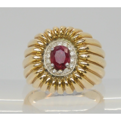 563 - An 18k gold ruby and diamond gents ring, size P1/2, weight 12.8gms