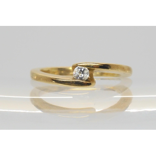 564 - A 9ct gold diamond cross over solitaire ring, set with a 0.10ct brilliant cut diamond, size L1/2, we... 