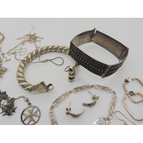 603 - A collection of silver and costume jewellery to include two tribal bangles, Macintosh style items et... 