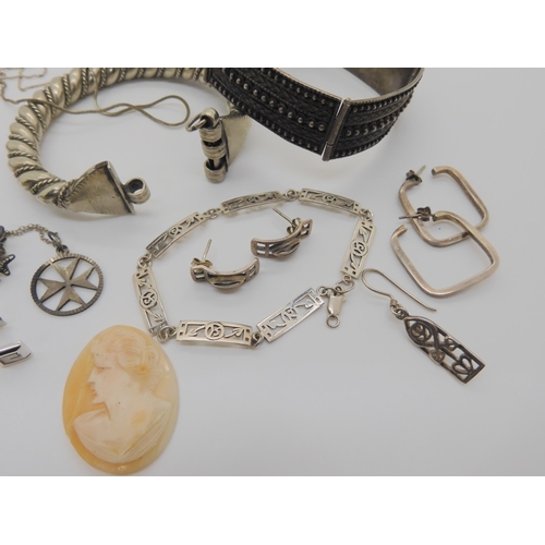 603 - A collection of silver and costume jewellery to include two tribal bangles, Macintosh style items et... 