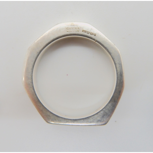 612 - A silver Gucci ring with London hallmarks and further stamped Gucci Reg. Made in Italy, size R1/2, a... 