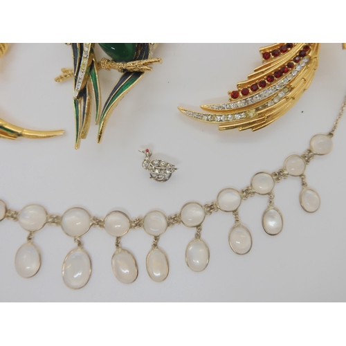 618 - A moonstone necklace, a white metal and diamante dress clip watch, large costume jewellery bird broo... 