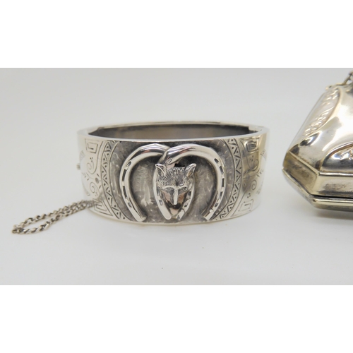 632 - A silver Lucky Fox bangle, hallmarked 1882, together with three white metal and silver charms and an... 