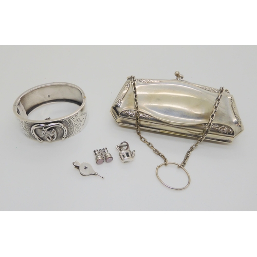 632 - A silver Lucky Fox bangle, hallmarked 1882, together with three white metal and silver charms and an... 