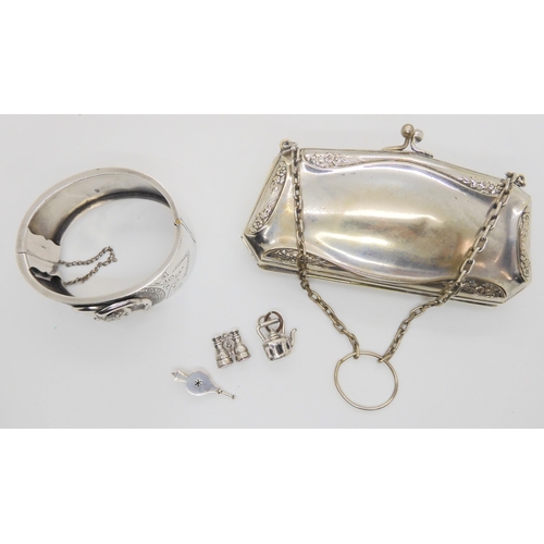 632 - A silver Lucky Fox bangle, hallmarked 1882, together with three white metal and silver charms and an... 