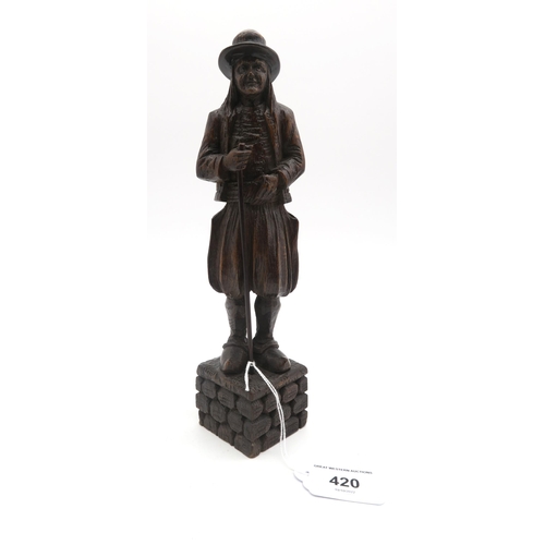 420 - A Black Forest carved figured of a man in continental country dress 