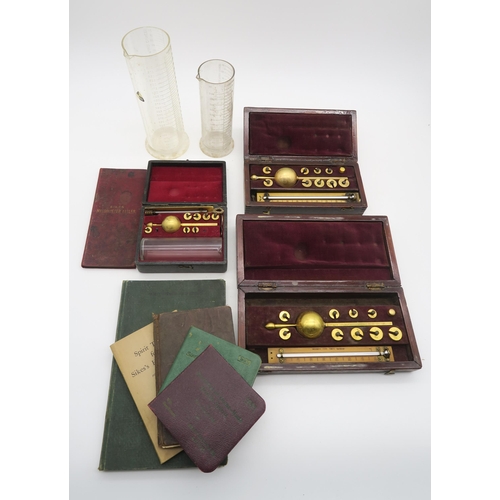 429 - A cased Sikes Hydrometer, two other cased hydrometers, measuring vessels and an assortment of corres... 