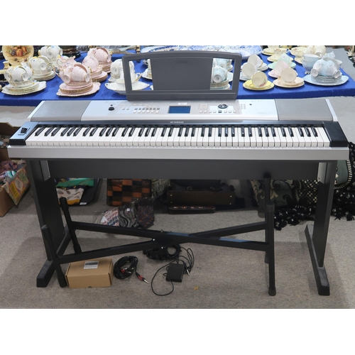 471 - A Yamaha Portable Grand DGX-520 electric piano with stand and accessories