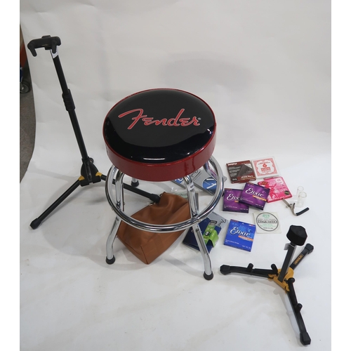 486 - FENDER guitar player's stool together with two Hercules guitar stands and various guitar strings, gl... 