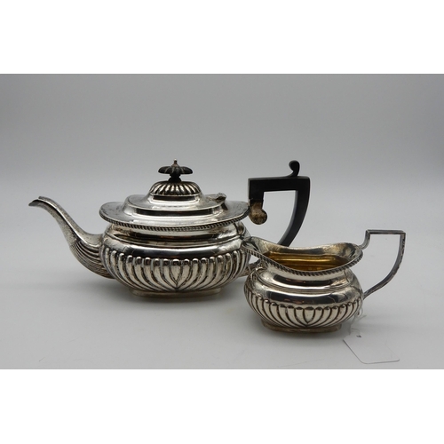 333 - A late Victorian silver tea pot, the body and domed lid lobed, the rim gadrooned, with ebonised hand... 