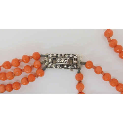 681 - A string of statement woven coral beads, with black glass beads and ribbon strap. Each woven bead is... 