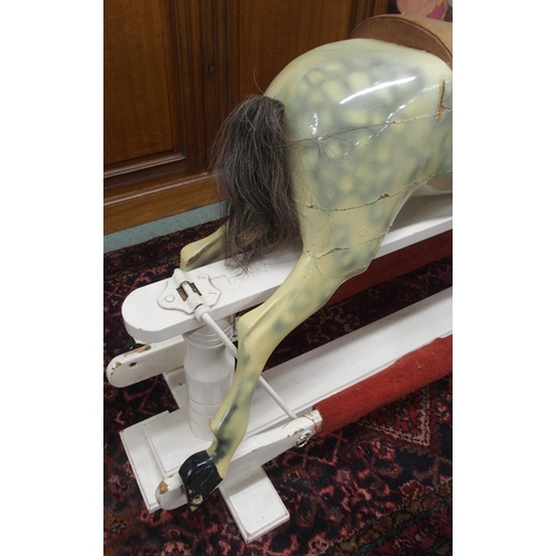 103 - An Edwardian child's rocking with leather reigns and saddle on white painted base, 105cm high x 147c... 