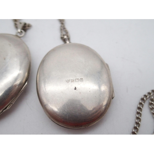 289 - An Elizabeth II silver photo locket pendant and chain, the oval body with coppered bird and engraved... 