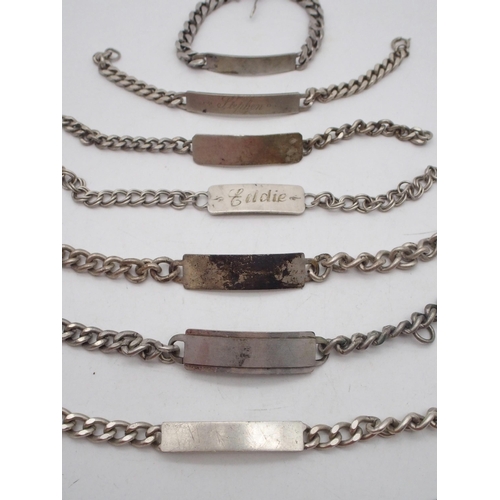 295 - A collection of silver and white metal identity bracelets, two engraved, one London 1982, another un... 