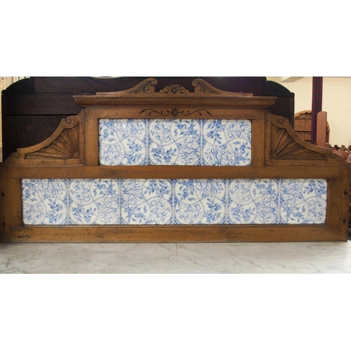 39 - A Victorian oak washstand with blue and white tiled splashback over marble top over single door on t... 