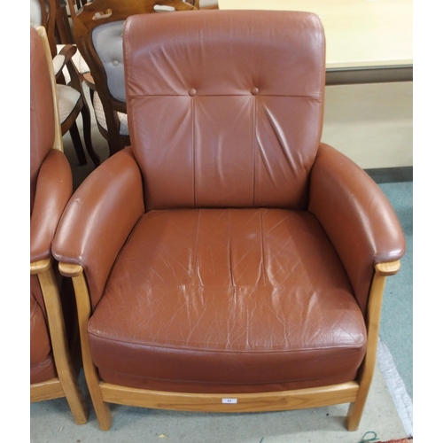 64 - A contemporary Ercol elm and beech framed and chocolate brown leather upholstered three piece suite ... 