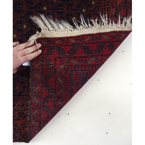 66 - A dark ground eastern prayer rug, 148cm long x 88cm wide