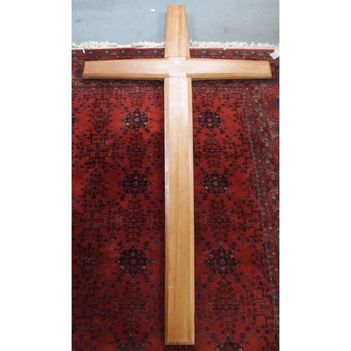 69 - A large beech churches cross fitted with back lighter, 277cm high x 153cm wide