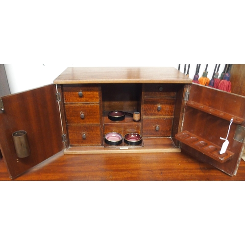 70 - An early 20th century mahogany smokers cabinet with two doors concealing extensively fitting interio... 