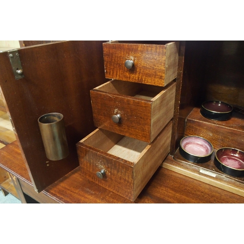 70 - An early 20th century mahogany smokers cabinet with two doors concealing extensively fitting interio... 