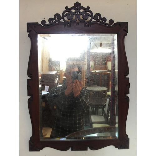 75 - A Victorian mahogany framed bevelled glass wall mirror, another Victorian oak oval framed bevelled g... 